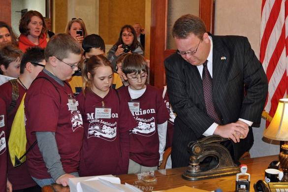 Secretary Gant demonstrates the old seal embosser for Madison fourth graders, Pierre, SD, March 1, 2011