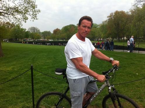 Arnold Schwarzenegger stops at Vietnam Memorial while bicycling around Washington DC, April 19, 2011