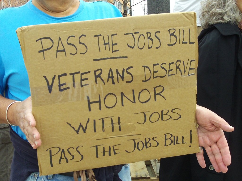 Sign at Occupy Rapid City protest, October 22, 2011: "Pass the Jobs Bill: Veterans deserve honor with jobs."