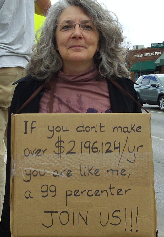 Sign at Occupy Rapid City protest, October 22, 2011: "If you don't make over $2,196,124/yr, you are like me a 99 percenter. JOIN US!!!"
