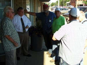 Citizens discuss the proposed community thrift store outside Madison City Hall, after the Madison City Commission forbade any public discussion of the topic at their July 9, 2012, meeting.
