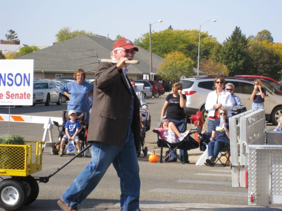 Charlie Johnson marches with a pitchfork in the DSU homecoming parade, Madison, South Dakota, September 29, 2012. Photo credit: Paula Herron Jensen