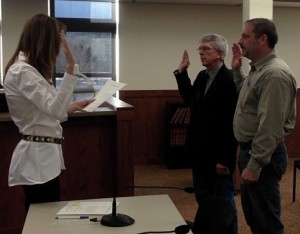 Auditor Lisa Schieffer swears in (center) Galen Niederwerder, Commissioner District 1, and (right) Steve Barry, Coroner, January 8, 2013.